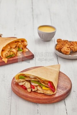 Chicken vegetable crepe with chicken crepe topped with melted cheese