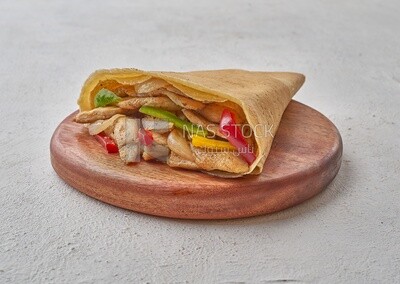 Grilled chicken crepe with vegetables on a solid background