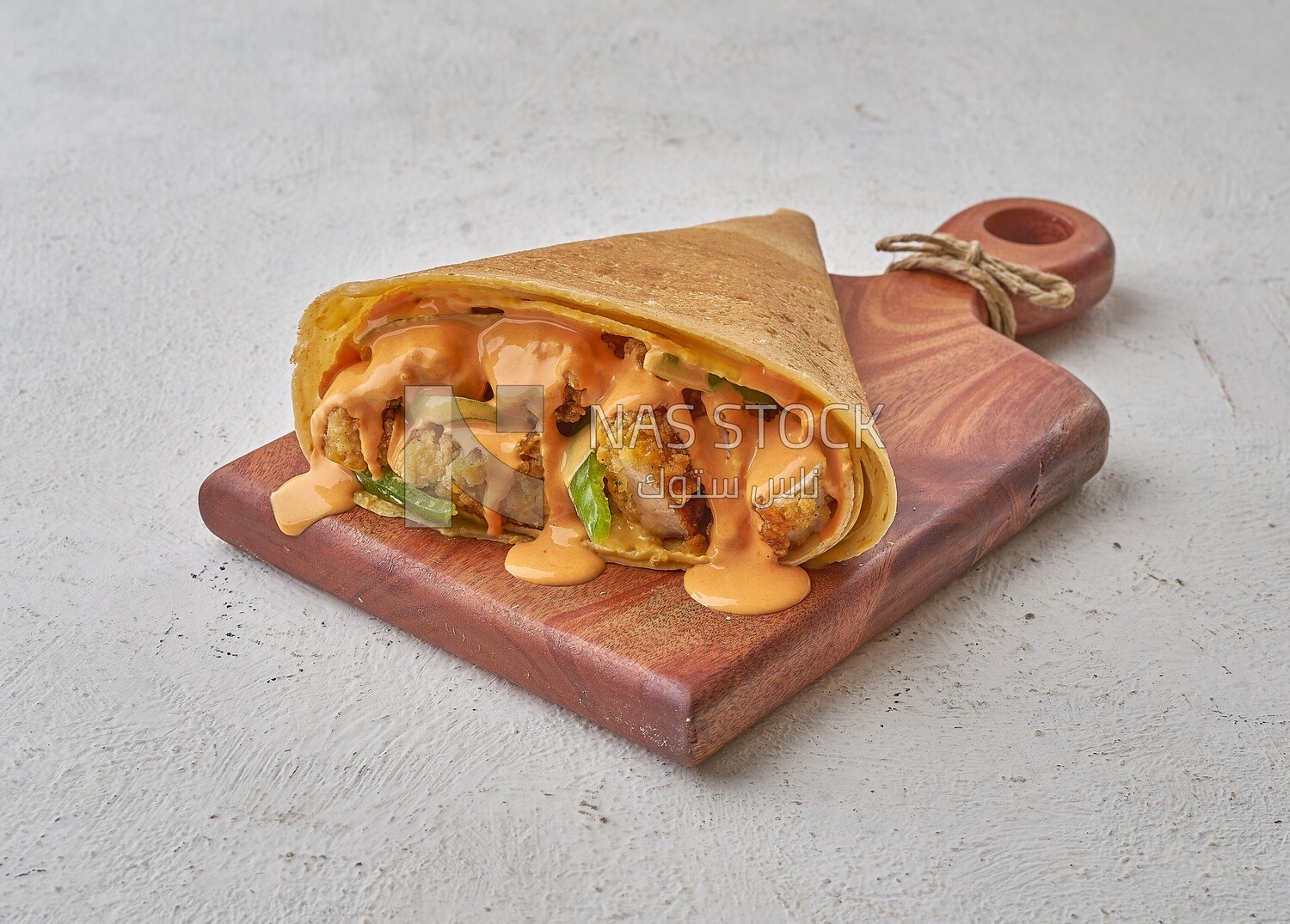 Crispy chicken crepe with melted cheese on a solid background