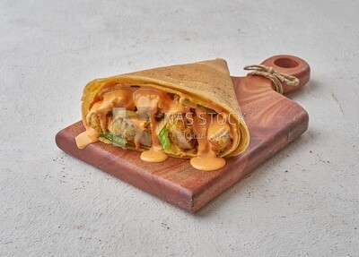 Crispy chicken crepe with melted cheese on a solid background