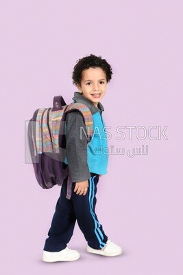 A boy wearing his bag