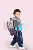 A boy wearing his bag