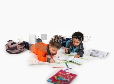 A brother and a sister sitting on the floor studying