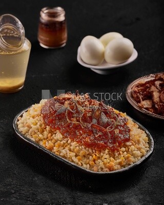 Alexandrian Koshari dish with red sauce and eggs