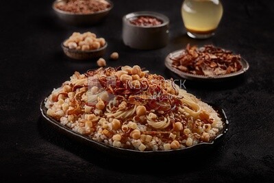 Egyptian Koshary dish with dishes of lentils and fried onions