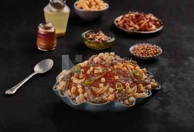 Egyptian koshary dish with liver and sliced hot pepper