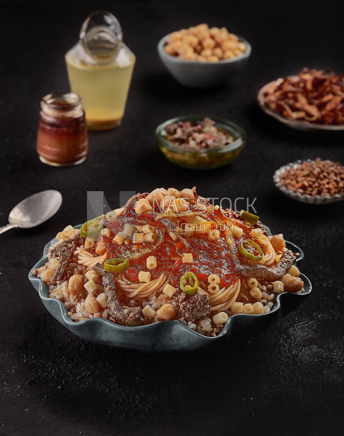 Egyptian koshary dish with liver and sliced hot pepper