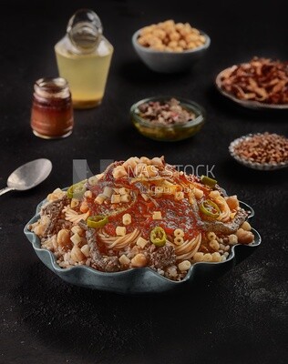 Egyptian koshary dish with liver and sliced hot pepper