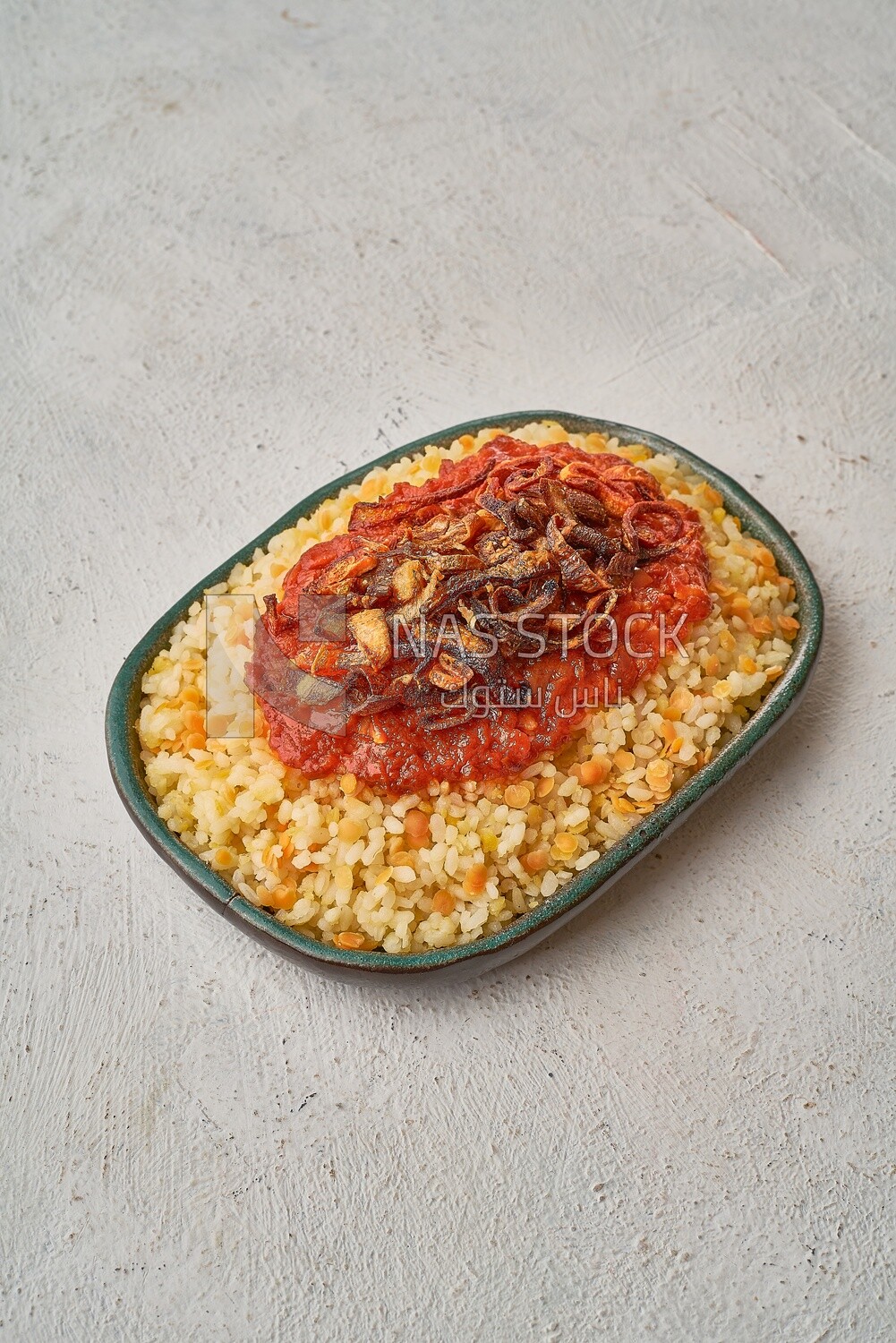 Alexandrian Koshari with red sauce and fried onions