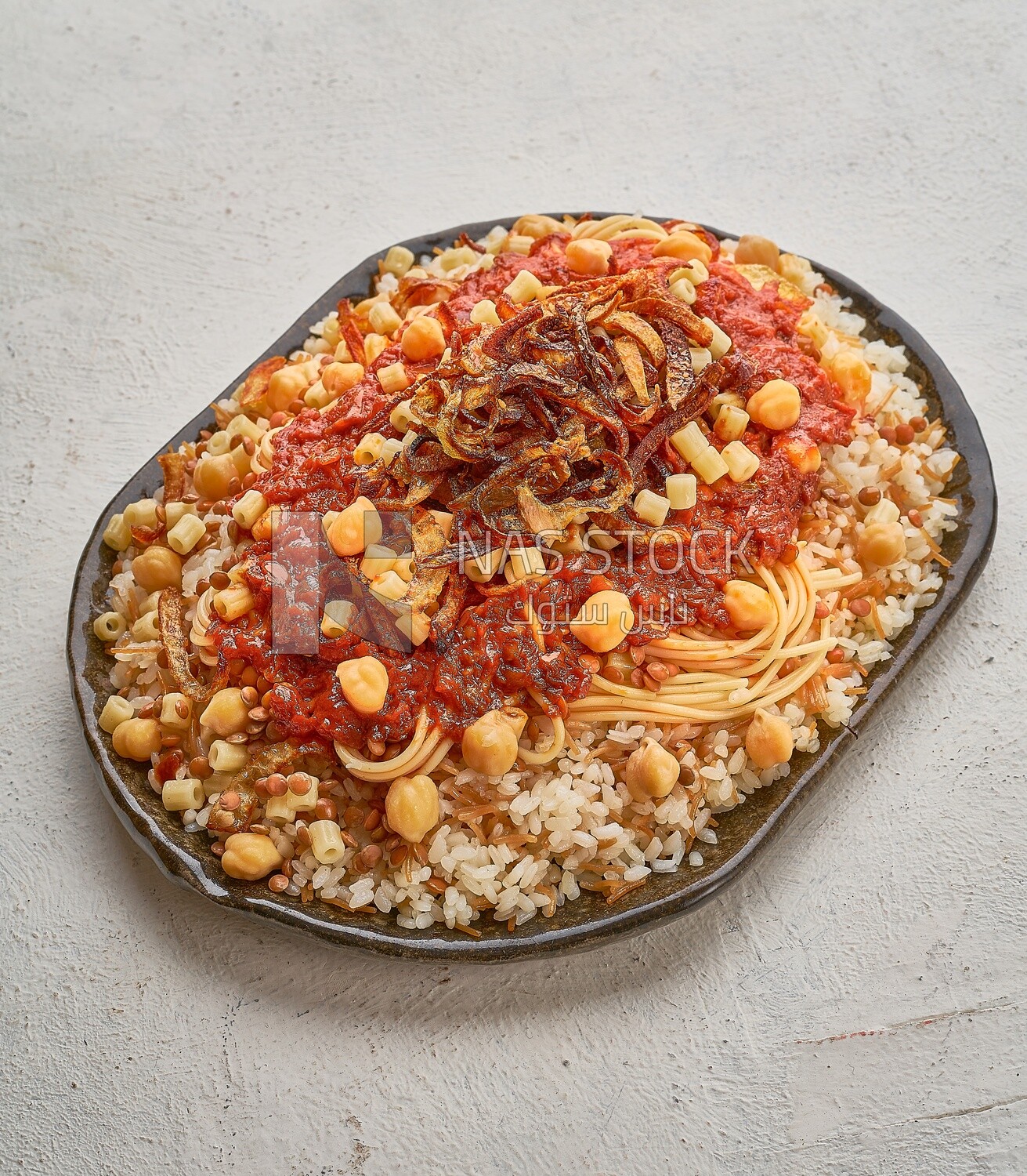 Egyptian Koshary with red sauce on a solid  background