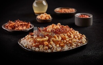 Egyptian Koshary dish with appetizers on dining table