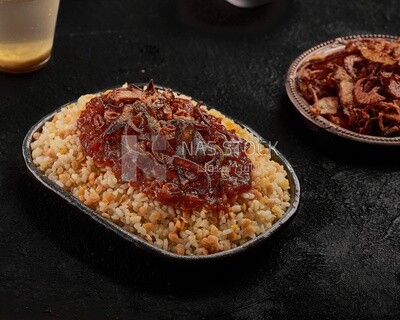 Alexandrian Koshari dish with red sauce