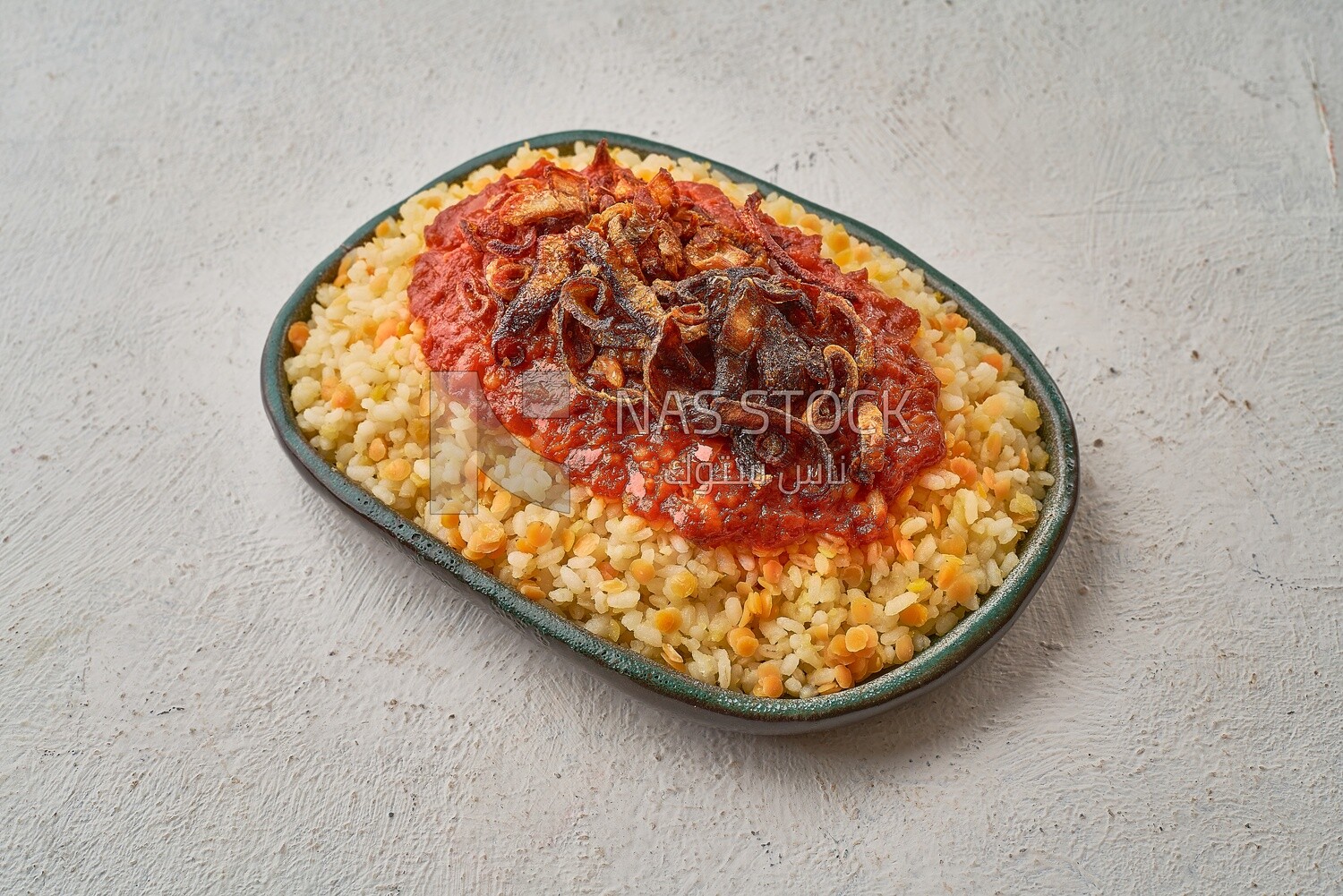 Alexandrian Koshari with red sauce and fried onions