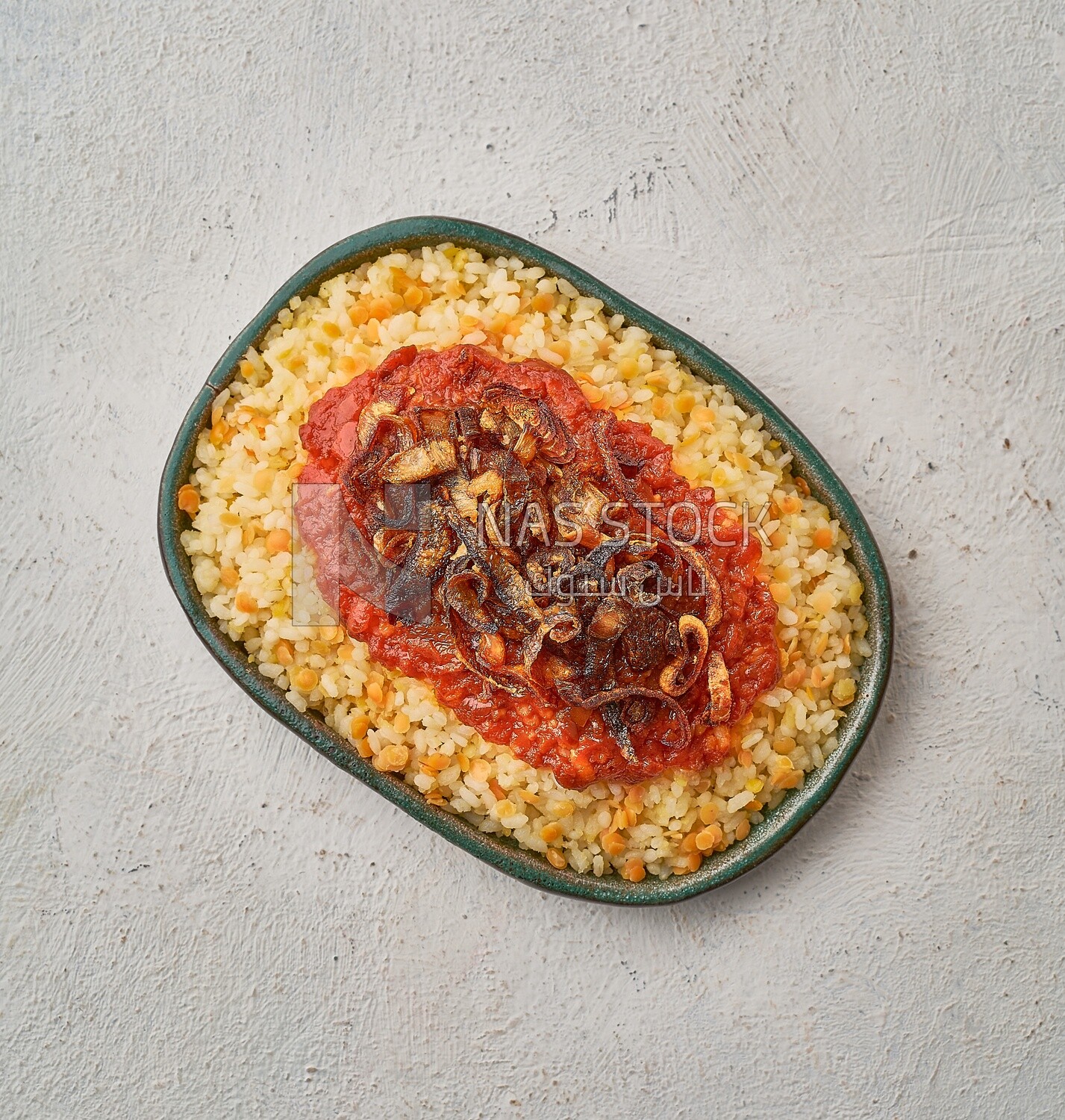 top view of an Alexandrian Koshari with red sauce