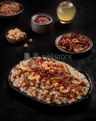 Top view of an Egyptian Koshary dish with appetizers