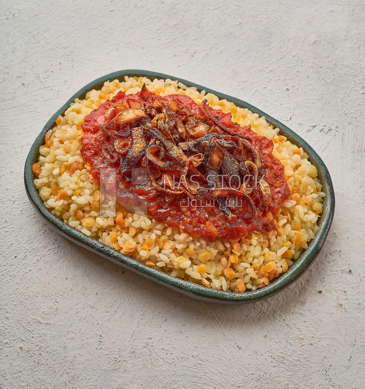 Alexandrian Koshari with red sauce on a solid  background