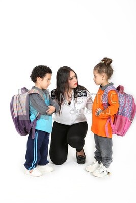 A mother sitting with her kids on a white background