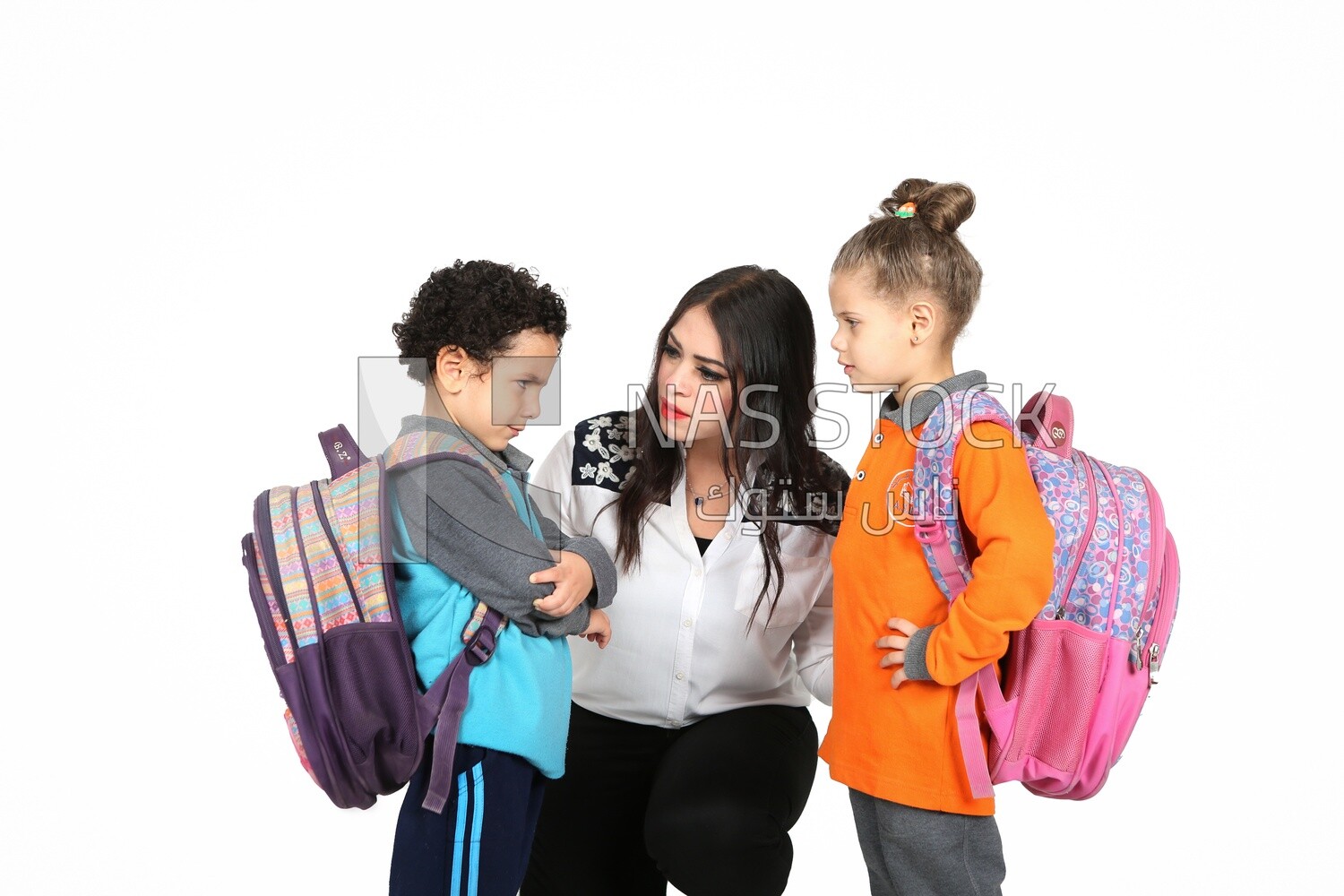 A mother sitting with her kids on a white background