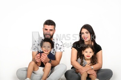 A family of four sitting on the floor