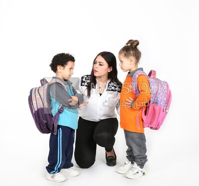 A mother sitting with her kids on a white background