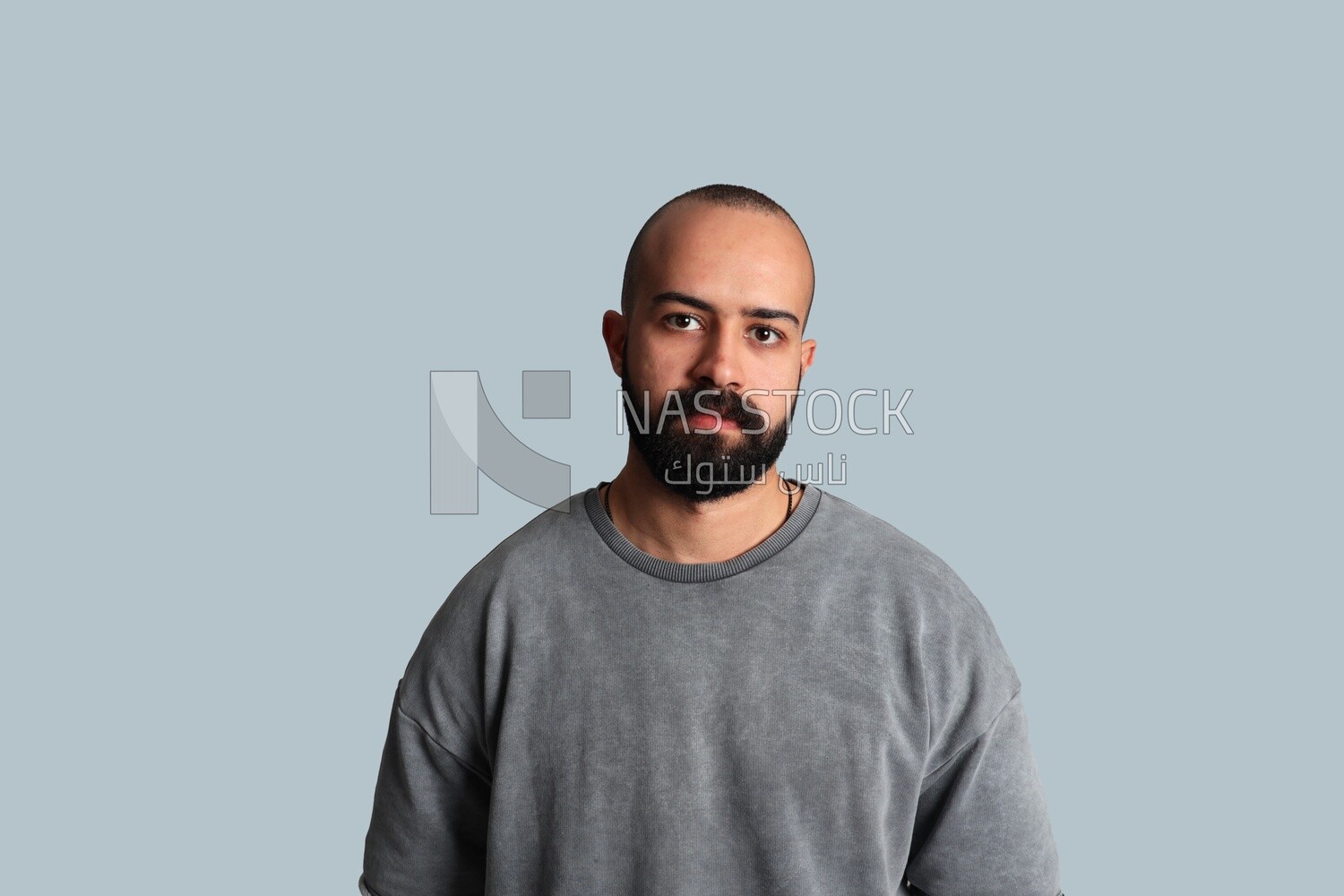 Portrait of a young man with a beard wearing a shirt