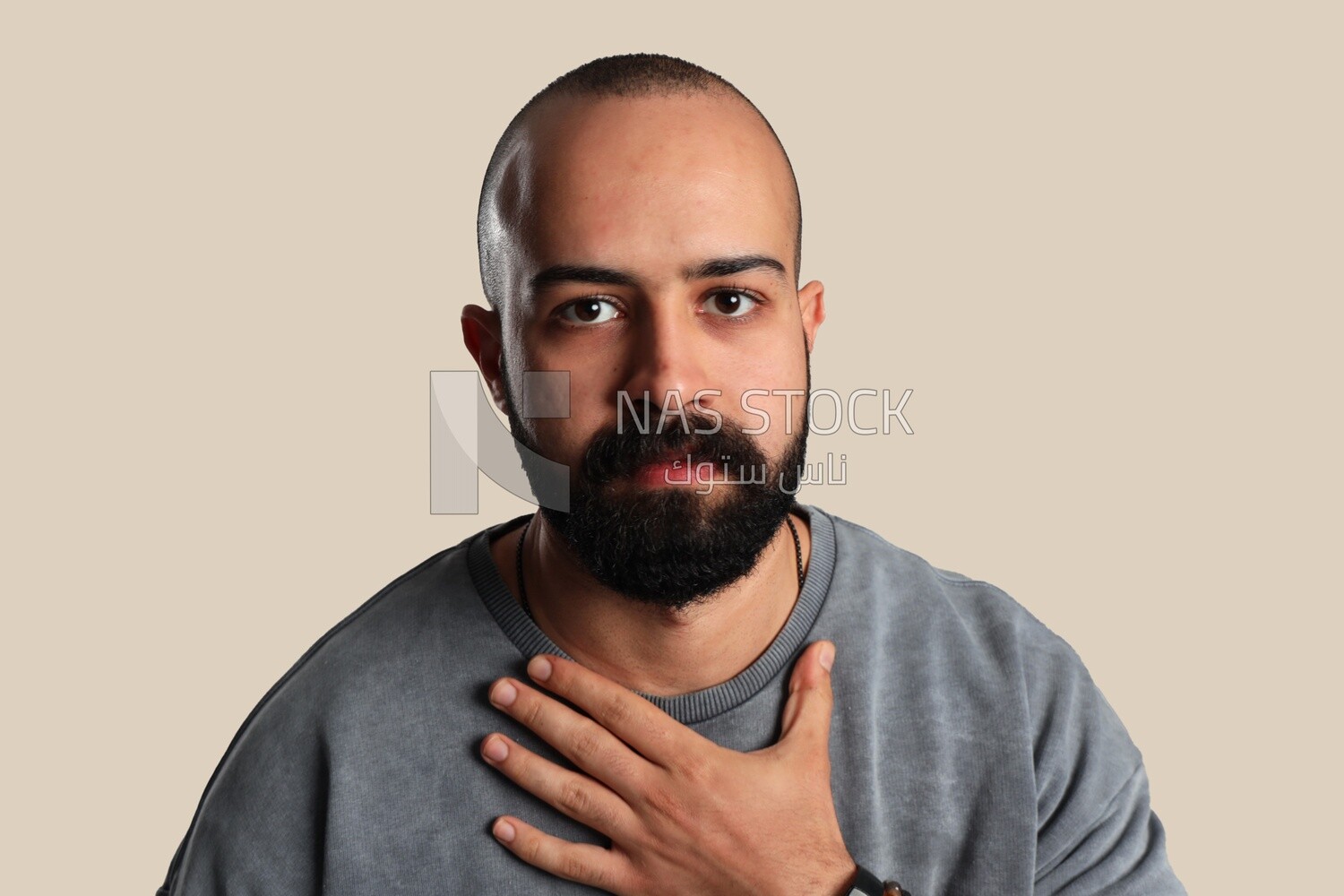 young man&#39;s hand on his chest