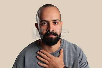 young man&#39;s hand on his chest