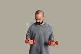 young man holding dumbbell