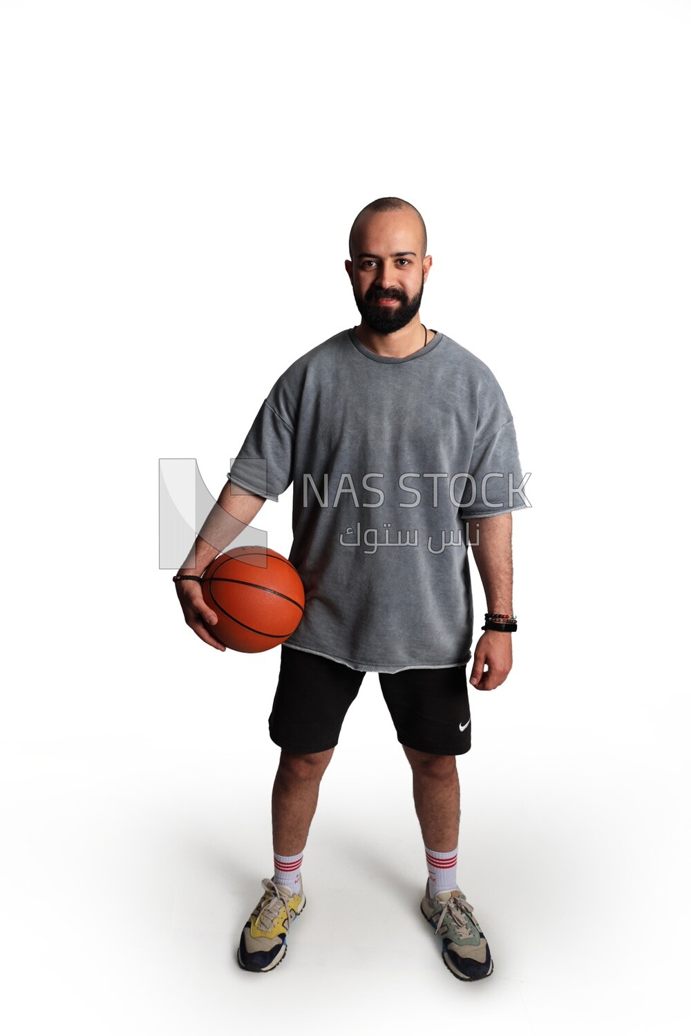young man wearing sportswear and holding a basketball