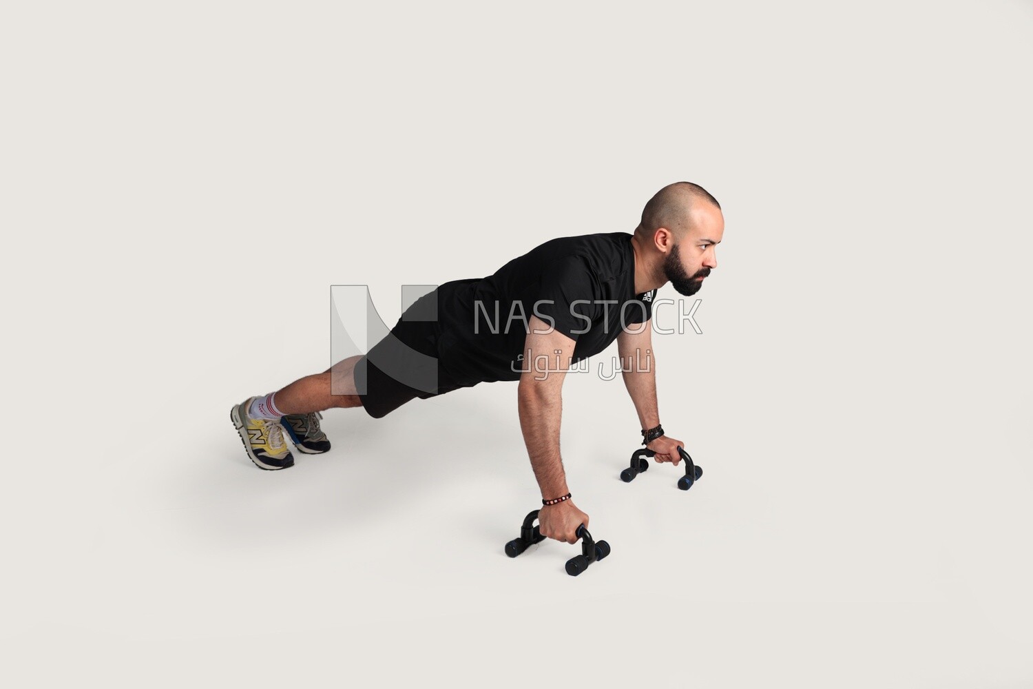 sportsman doing push ups with gym equipment