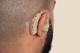 hearing impaired earphone in a man&#39;s ear