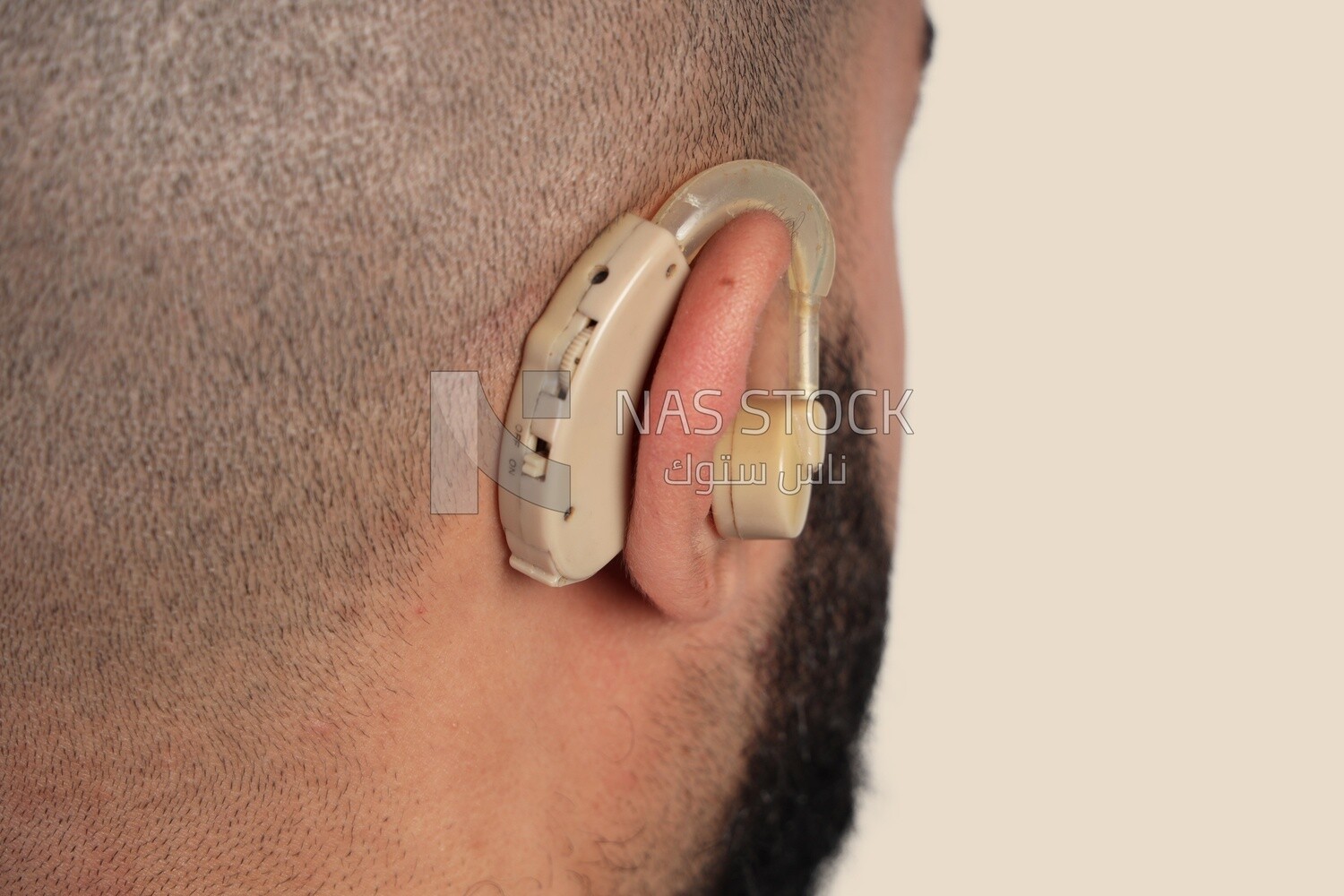 hearing impaired earphone in a man&#39;s ear
