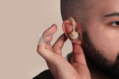 Close-up of a man installing a headset in his ear