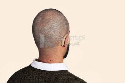 hearing aid in a man&#39;s ear ,back view
