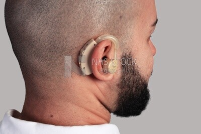 hearing aid installed in a man&#39;s ear