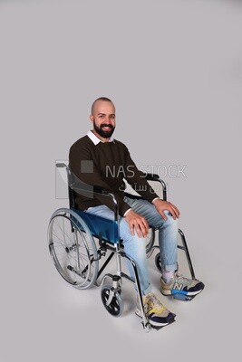Disabled man in a wheelchair smiling positively