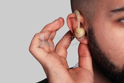 Close-up of a man installing a headset in his ear