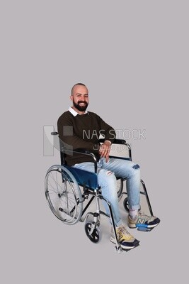 Disabled man in a wheelchair smiling positively