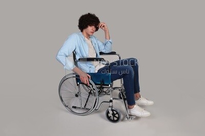 Disabled man in a wheelchair, desperate and sad