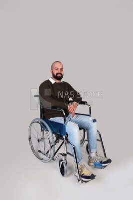 Disabled man in a wheelchair smiling positively