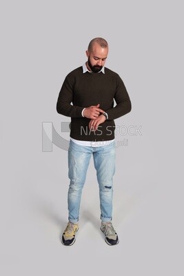 young fashion model looking at his watch