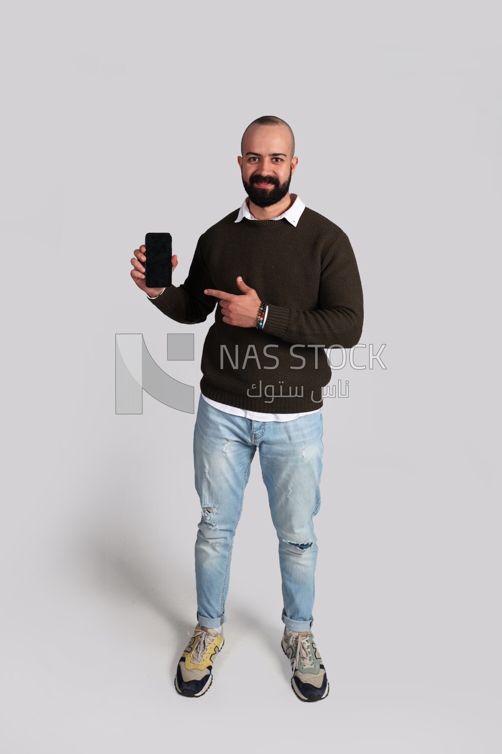 man standing and pointing at his smartphone