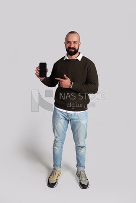 man standing and pointing at his smartphone
