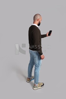 man standing and browsing his phone