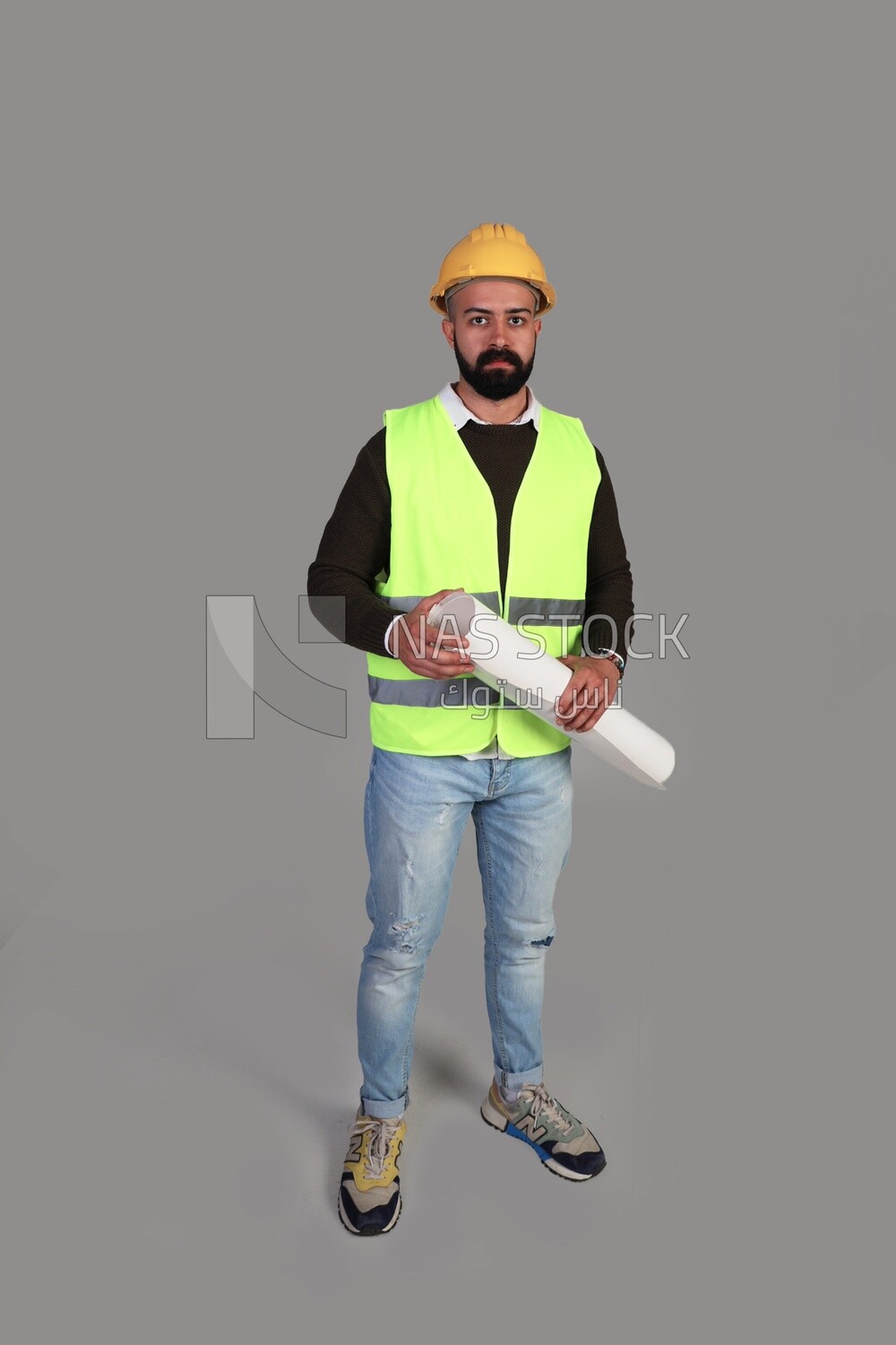 engineer in work clothes and construction maps