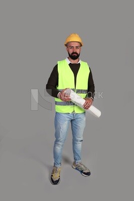 engineer in work clothes and construction maps
