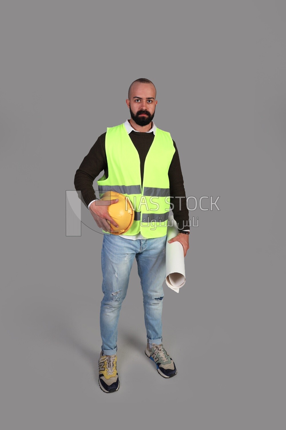 engineer in work clothes and construction maps