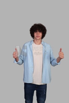 handsome young man raising his thumb up