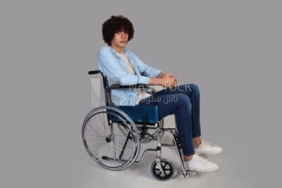 disabled young man with thick curly hair sitting in a wheelchair