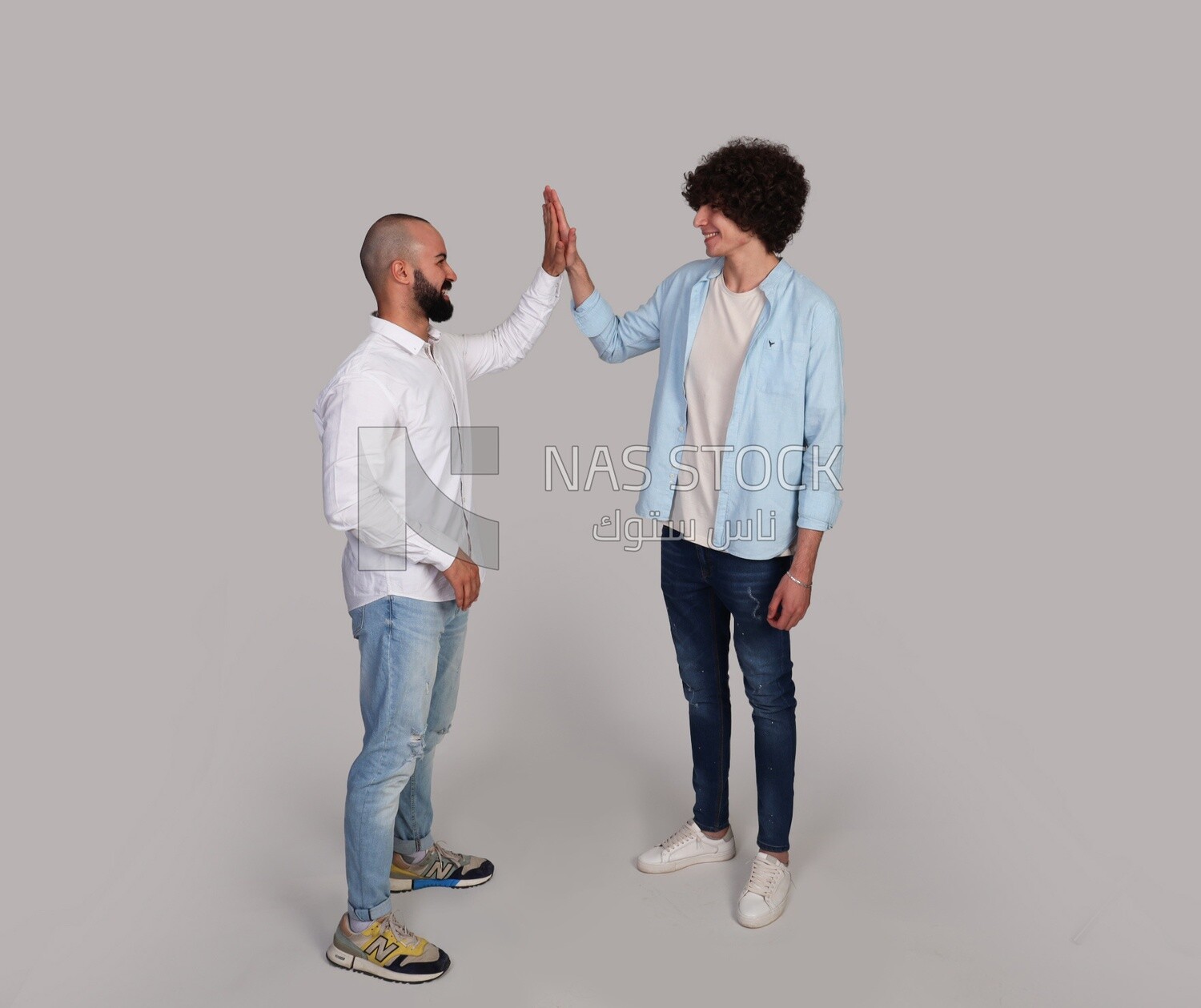 two friends shaking hands happily